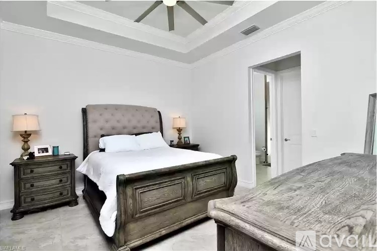 A bedroom with a large bed and a smaller bed in the corner.