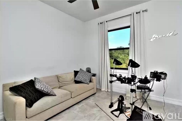 A living room with a couch, pillows, and a camera setup.