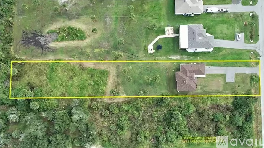 A property is outlined in yellow on an aerial image.