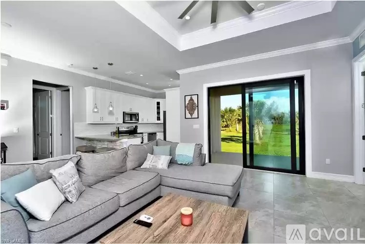 A modern living room with a grey sofa and a wooden coffee table.