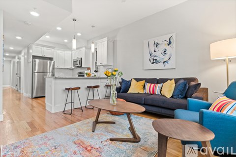 A modern living room with a blue couch and a wooden coffee table.