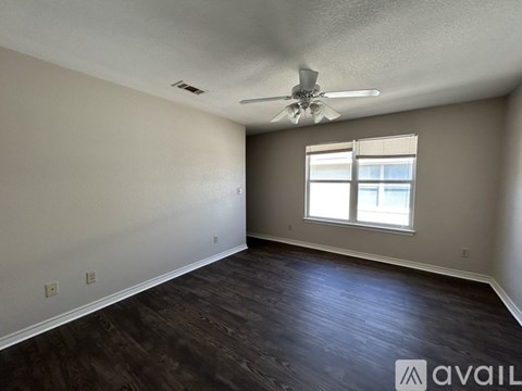 A room with a ceiling fan and a window.