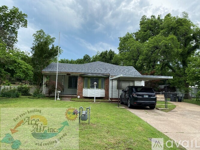A house with a car parked in front and a sign that says "Ace Air Inc.".