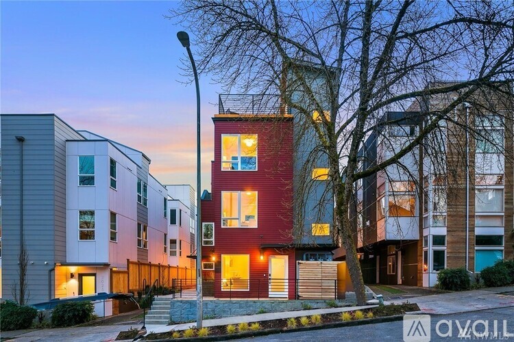 A red building with a sign that says "avail" in front of it.