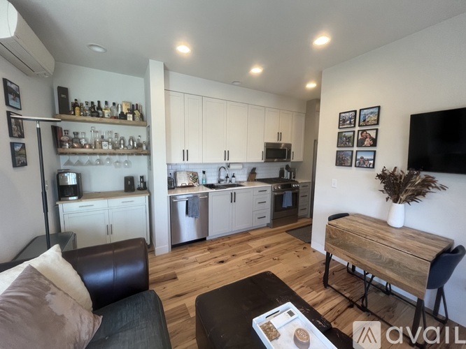A modern kitchen with white cabinets and stainless steel appliances.