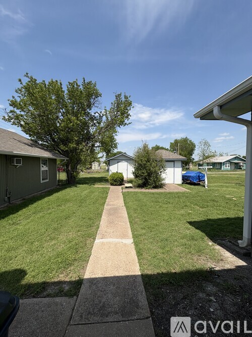 A residential area with houses and a clear sky.