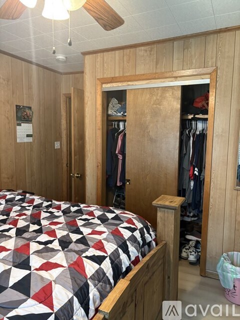 A bedroom with a bed and a wardrobe.
