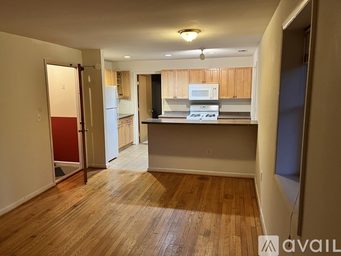 A kitchen area with a refrigerator, microwave, and oven.