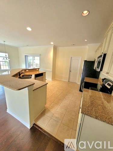 A kitchen with white cabinets and a countertop.