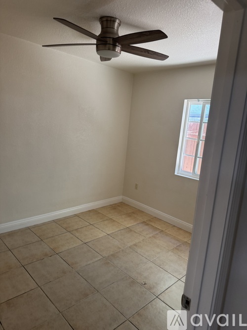 A bathroom with a toilet, tub, and tiled floor.
