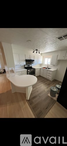 A kitchen with a white table and a white ceiling.