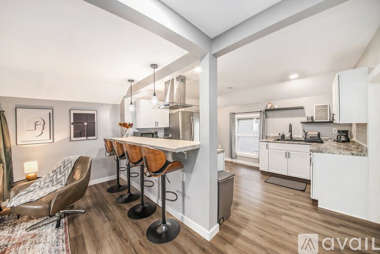 A kitchen with a bar area and a dining table.