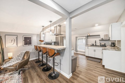 A kitchen with a bar area and a dining table.