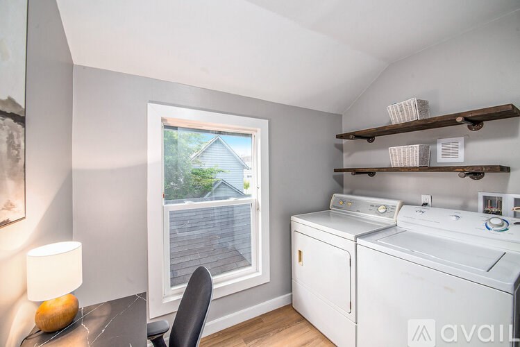 A small laundry room with a washer and dryer.