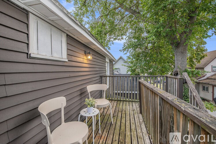 A small balcony with a table and two chairs.