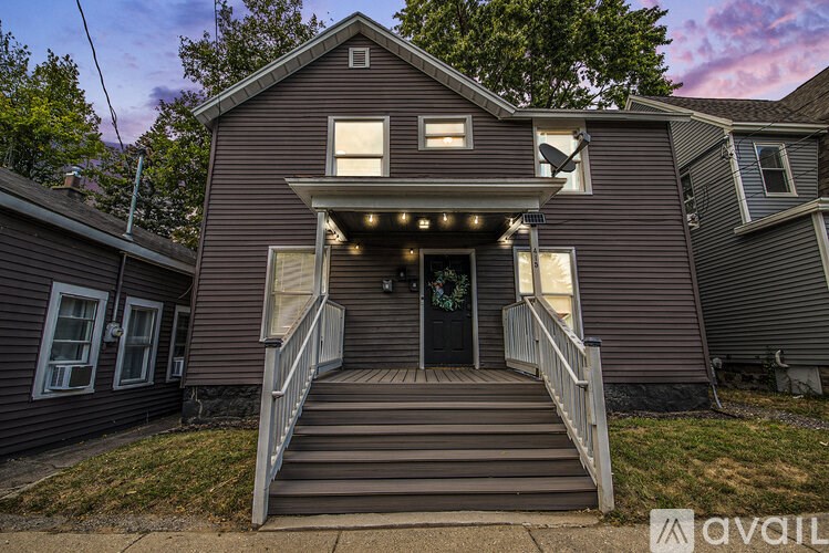 A house with a front porch and a garage door.