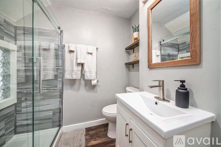 A bathroom with a white sink and a mirror.