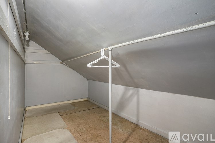A room with a hanger on the wall and a mat on the floor.