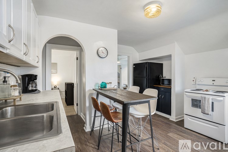 A kitchen with a table and chairs in the middle of it.