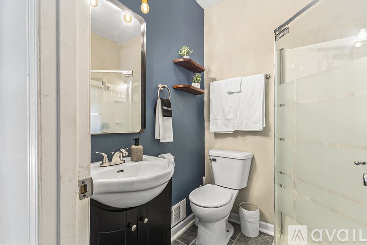 A bathroom with a sink, toilet, and shower.