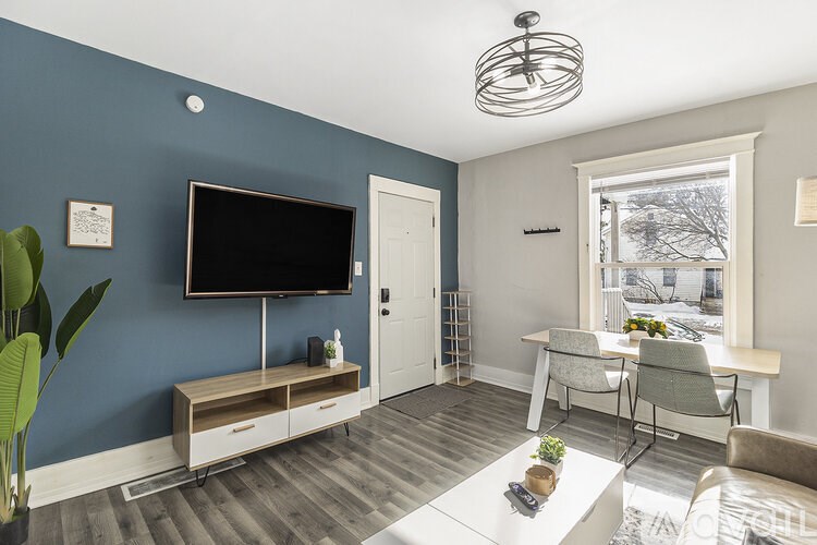 A living room with a television and a chair.