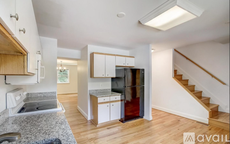 A kitchen with a granite countertop and stainless steel appliances.