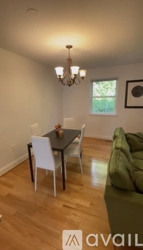 A dining room with a table and chairs.