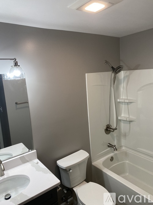 A bathroom with a toilet, sink, and bathtub.