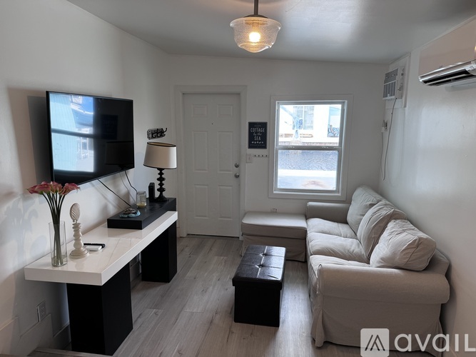 A living room with a couch, a television, and a coffee table.