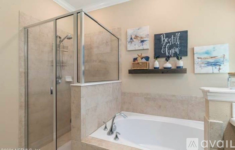 A bathroom with a tub, shower, and a chalkboard on the wall.