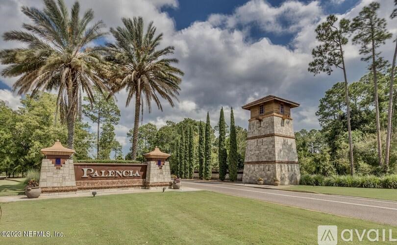 A sign that says Palencia stands in front of a grassy area.