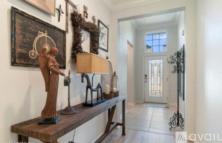 A room with a wooden bench and a statue on it.