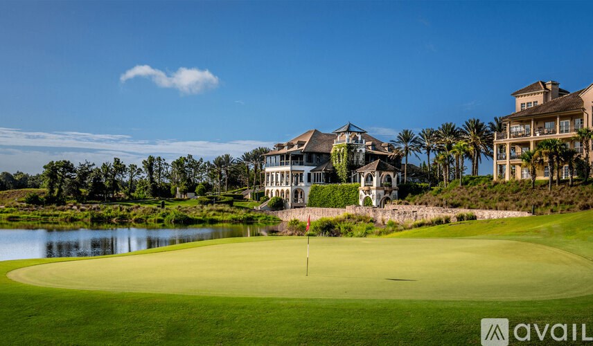 A golf course with a large house in the background.
