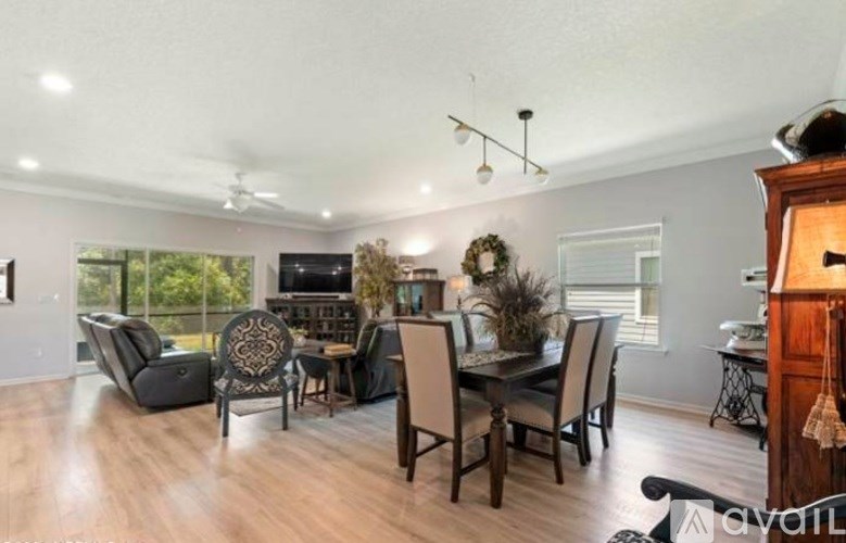 A living room with a dark wood floor and furniture.