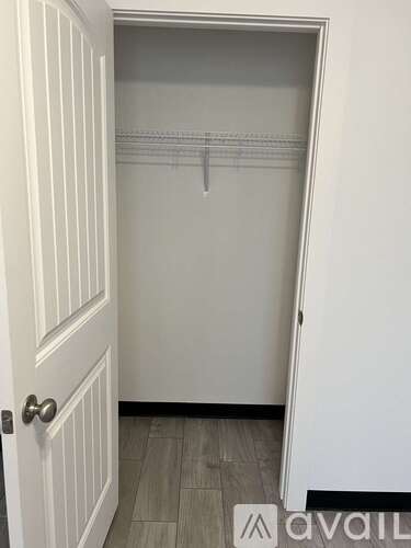 A white door with a handle and a sign that says "avail" on the floor.