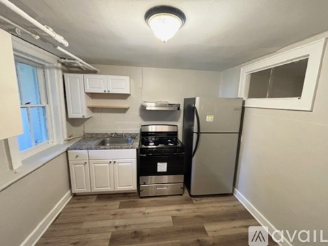 A kitchen with a stove, oven, and refrigerator.