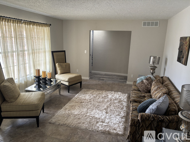 A room with a ceiling fan and sliding glass doors.