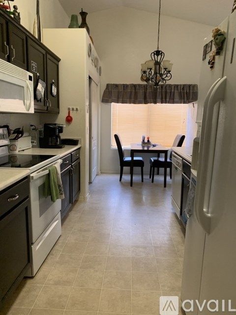 A kitchen with a table and chairs in the middle of the room.