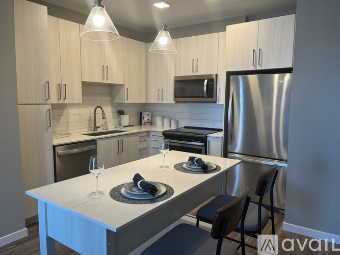 A kitchen with a table set for two.