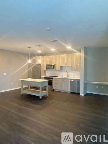 A kitchen area with a table and a refrigerator.