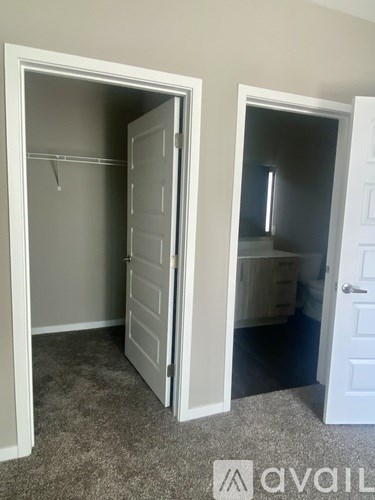 Two white closet doors open to reveal empty rooms.