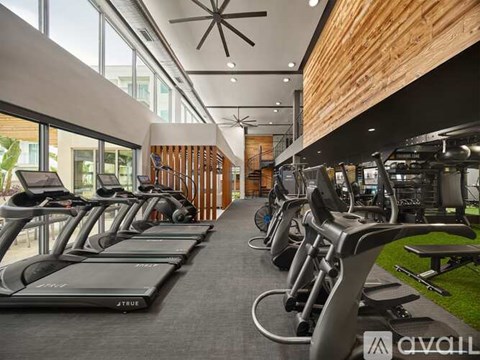 A gym with treadmills and exercise equipment.