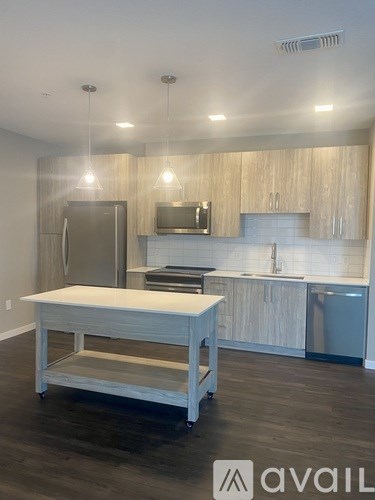 A kitchen with a wooden island in the middle.