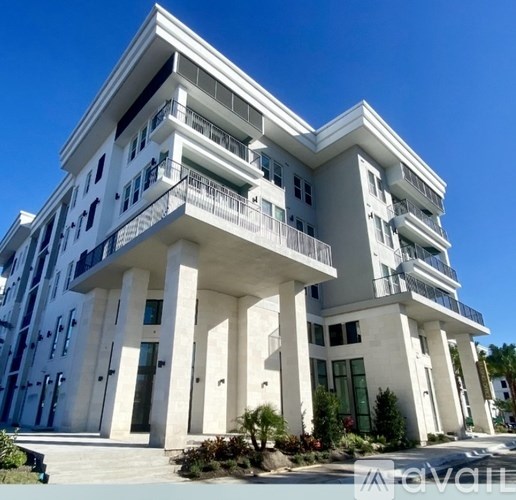 A white building with balconies and columns.