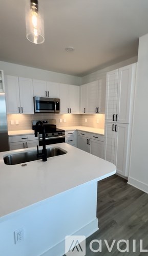 A living room with a couch, chair, and dining table.
