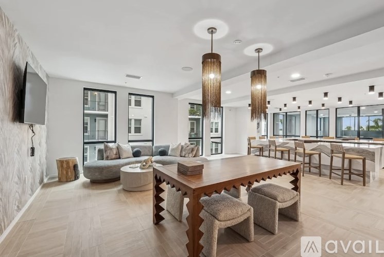 A modern kitchen with a stainless steel sink and white countertops.