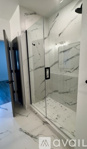 A bedroom with a large bed and a ceiling fan.