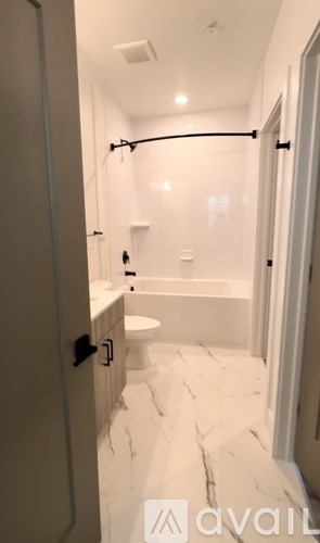 A bathroom with a toilet, sink and bathtub.