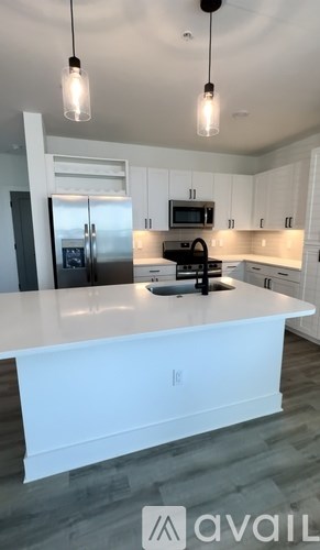 A modern kitchen with white cabinets and a large island.
