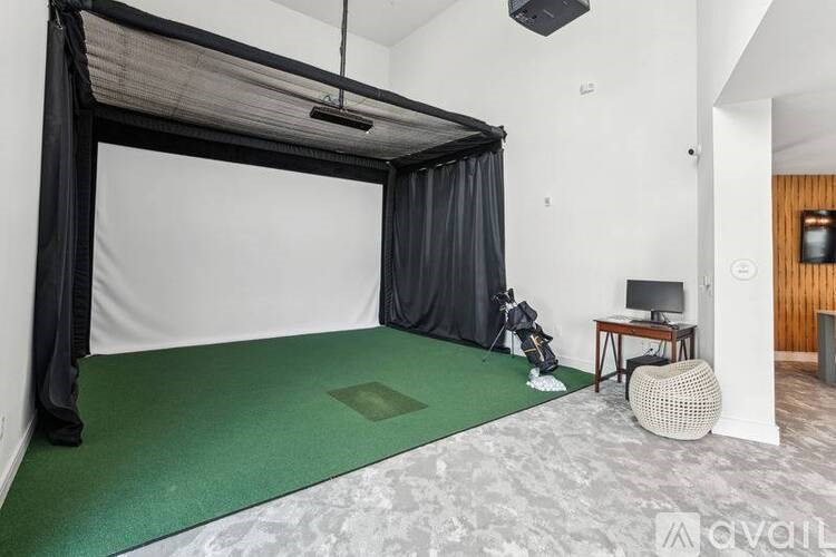 A room with a green mattress and a black canopy bed.